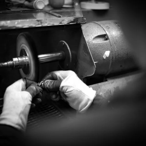 A craftsman polishing Suturno sterling silver figurines