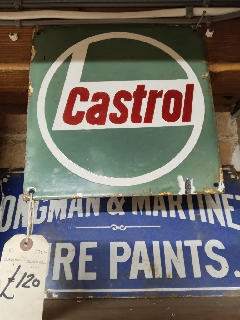 A vintage metal sign for Castrol hanging from the ceiling.