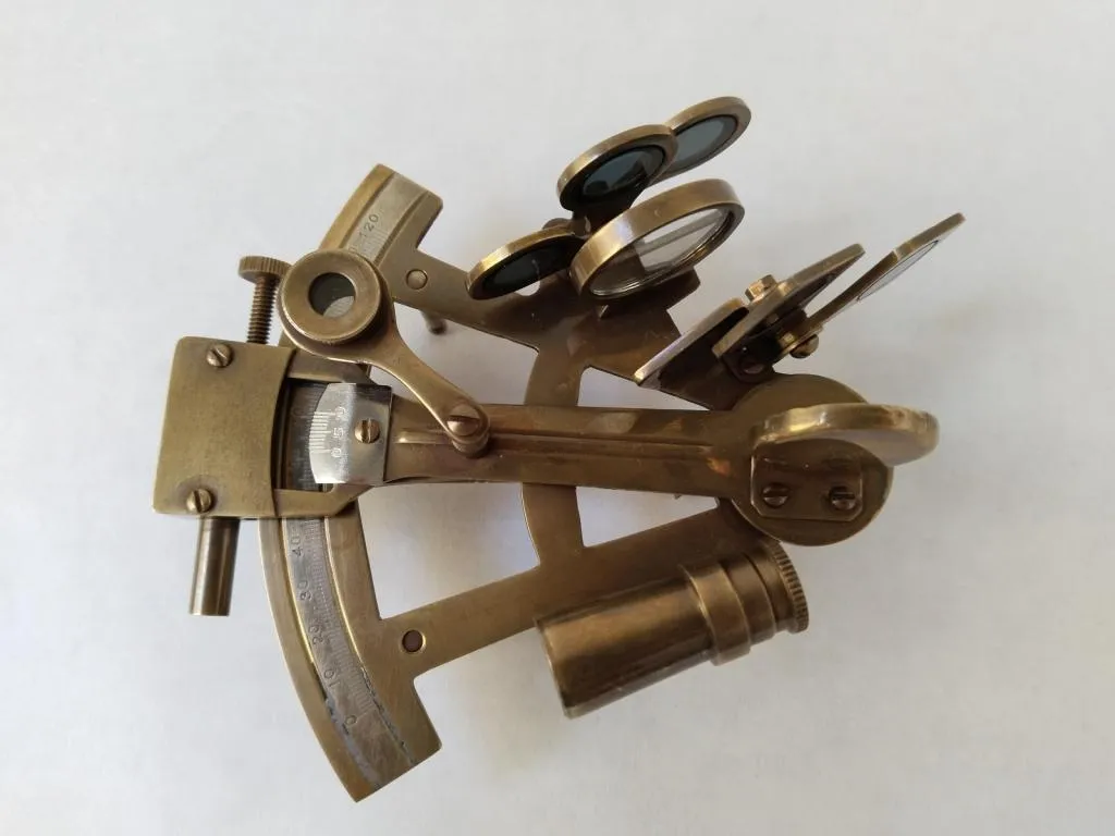 A brass nautical sextant, a classic instrument for celestial navigation.