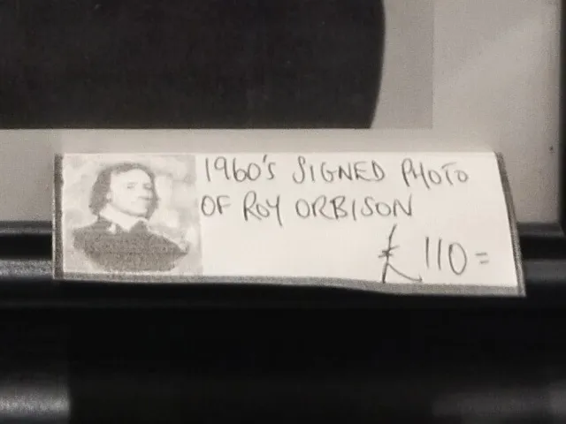 AI-generated image description: This is the price tag in the Cromwell Antique Center for a signed photo of Roy Orbison. The tag reads 