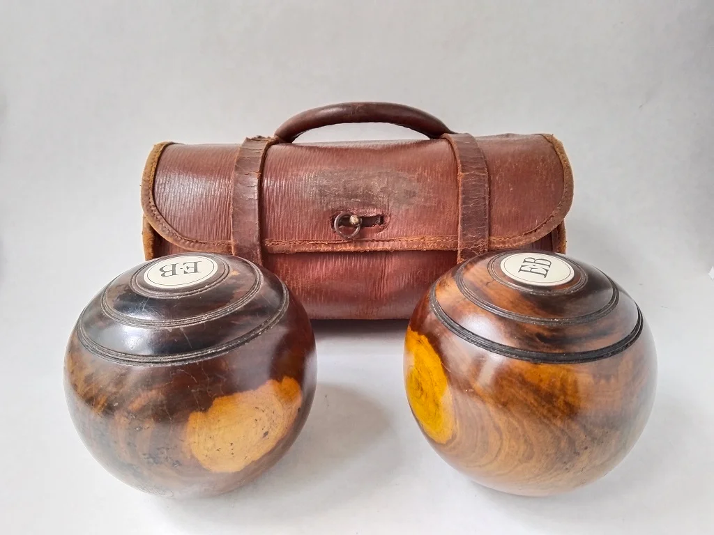 Pair of EJ Riley Lignum Vitae lawn bowls from 1950 belonging to Edwin 'Percy' Baker.