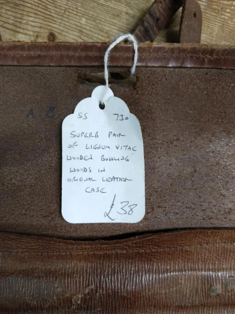 The original price tag for the Lignum Vitae lawn bowls, purchased at Waterside Antiques for £38, still attached to their original leather case.