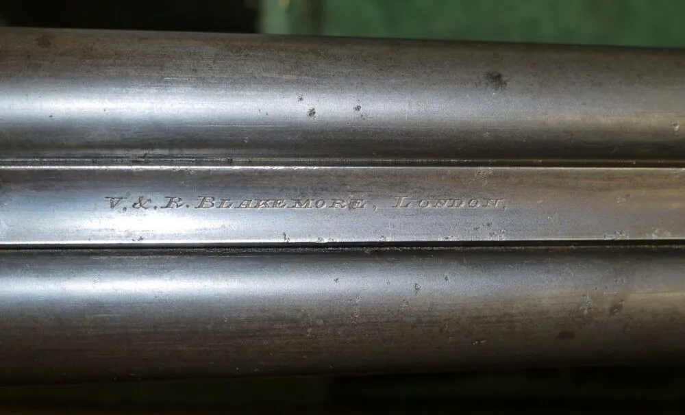 Close-up of the V&R Blakemore name engraved on a shotgun barrel, marking their presence in firearm manufacturing.