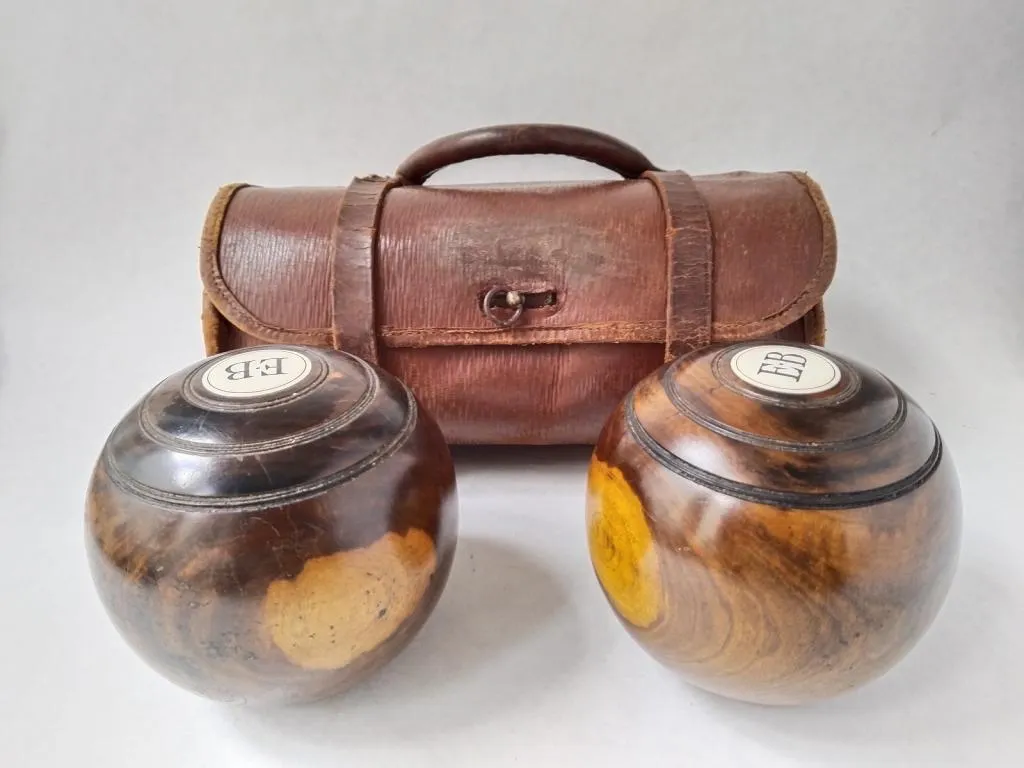 This pair of Lignum Vitae lawn bowls, housed in a leather bag, once belonged to the legendary lawn bowls champion Percy Baker.