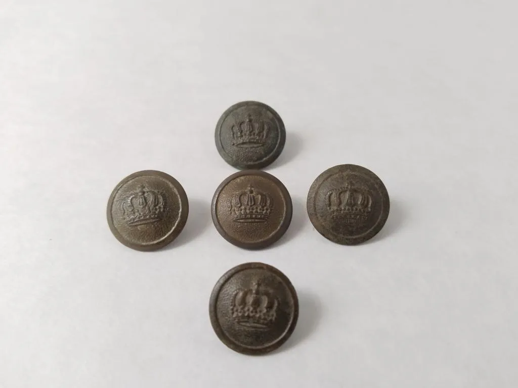 A set of five Romanian military buttons embossed with the Steel Crown of Romania, symbolizing the country’s independence.