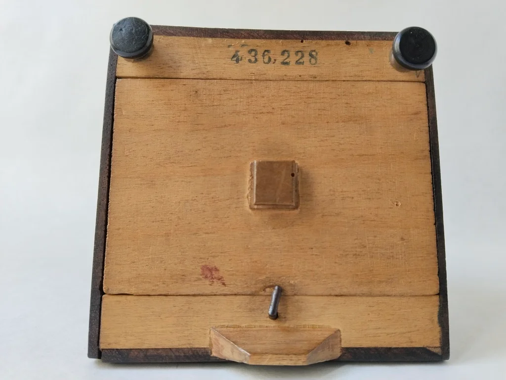 Bottom of a Maelzel metronome with visible serial number for determining the year of production.