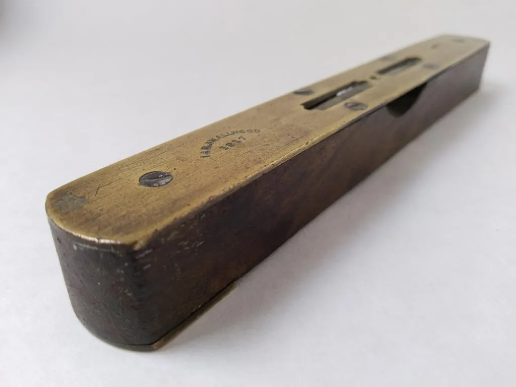 Brass and oak wood spirit level by I&D Smallwood, Birmingham, discovered at Emporium Antiques Center in Lewes.