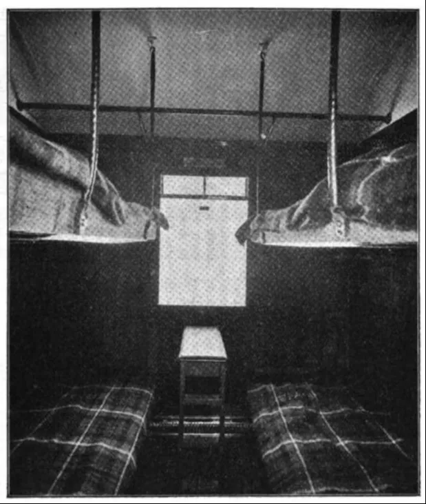 Another perspective of the third-class sleeping car’s interior, displaying the arrangement of upper and lower berths for passengers.